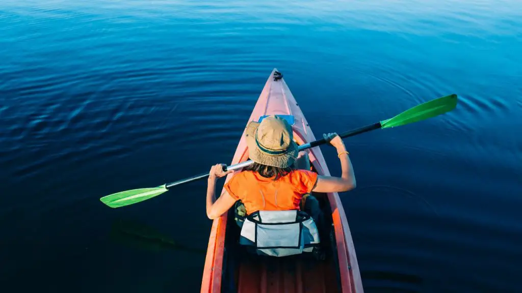 Girl rowing boat while sitting on padded chair