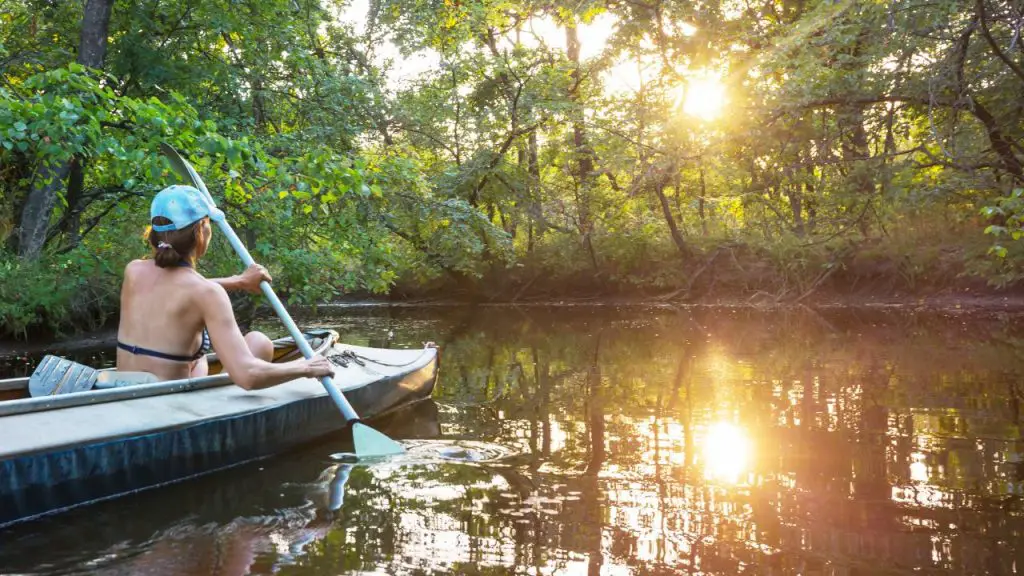 The girl is going on an adventure and rowing the Tandem Kayak alone