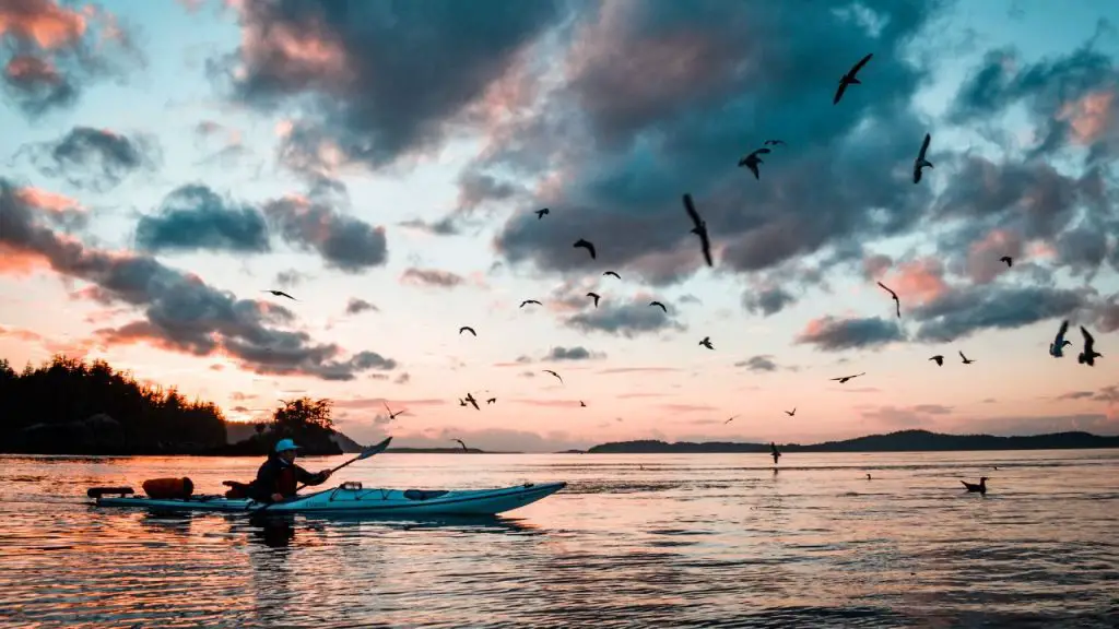 A Woman is riding on Kayak at Middle of Sea