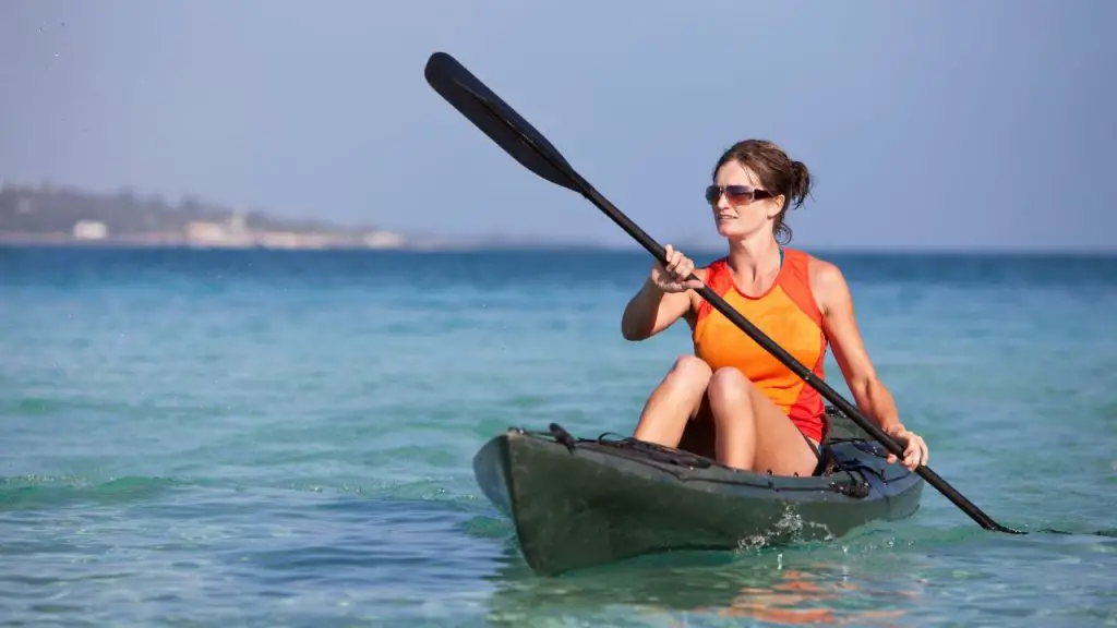 A girl is kayaking in the sea