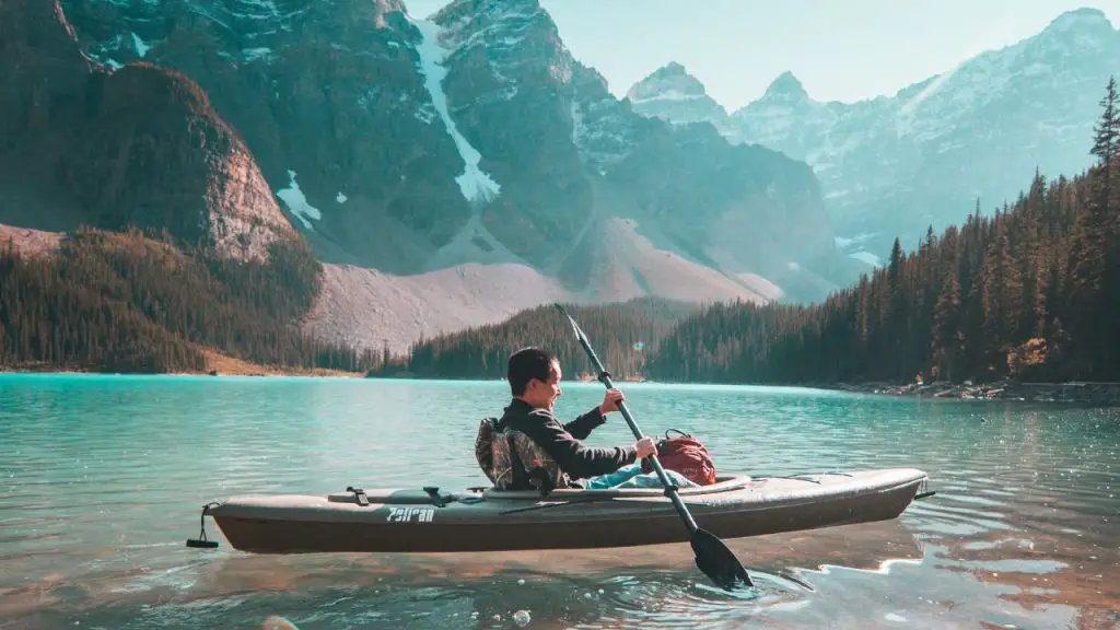 A man is riding on Gray Kayak