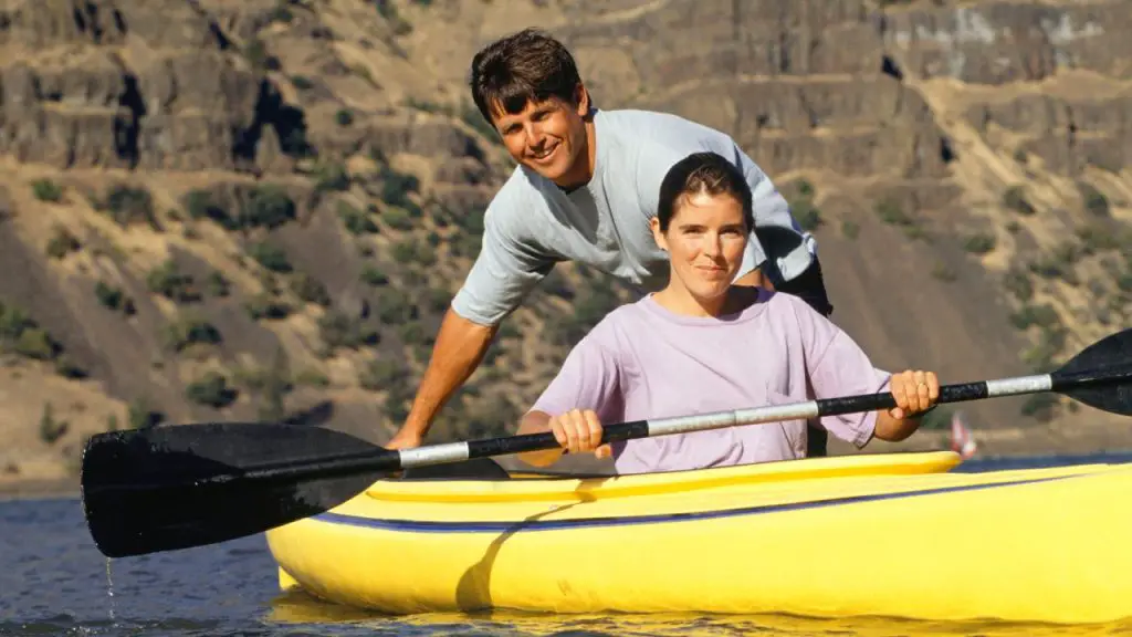 Couple kayaking on lake
