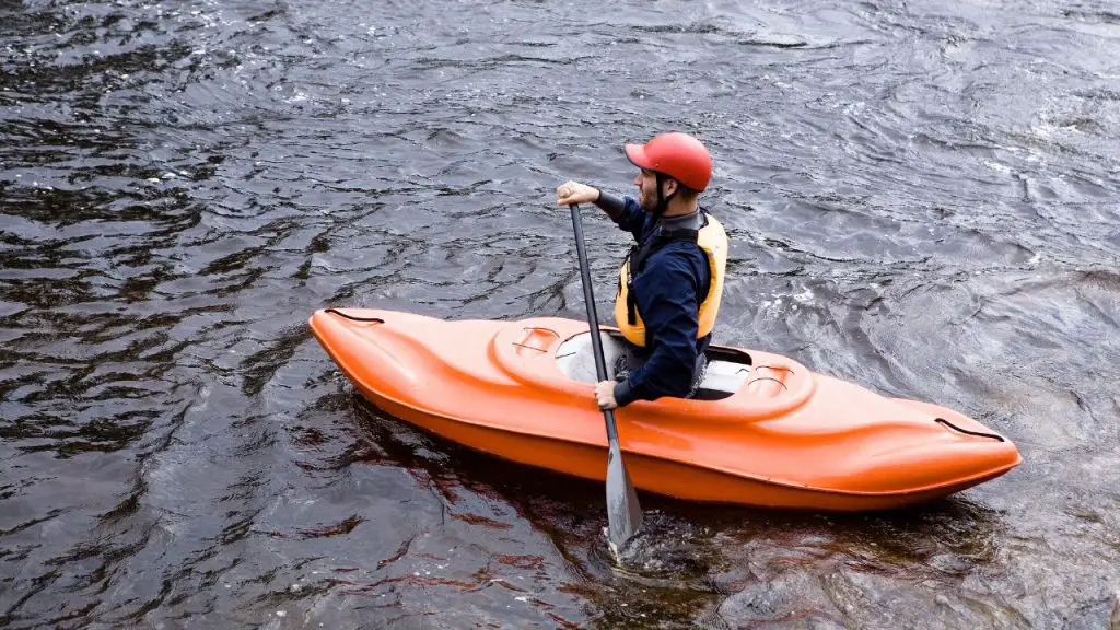 Kayaker paddling kayak in river