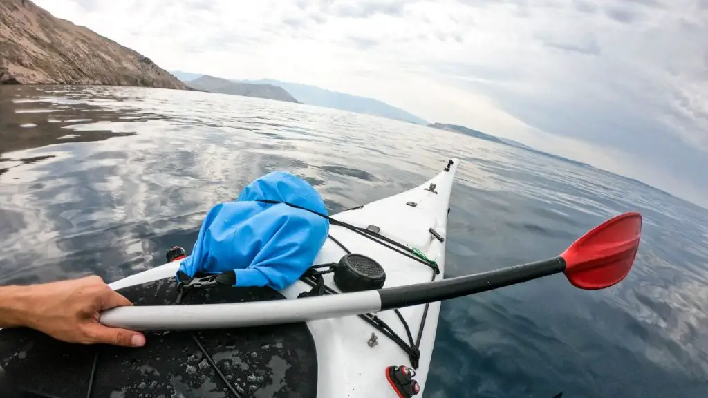 Kayaking front with oar and waterproof bag