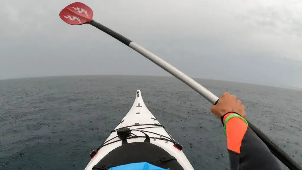 Kayaking on sea in rain