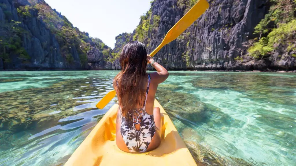 Woman is Kayaking on the yellow kayak 