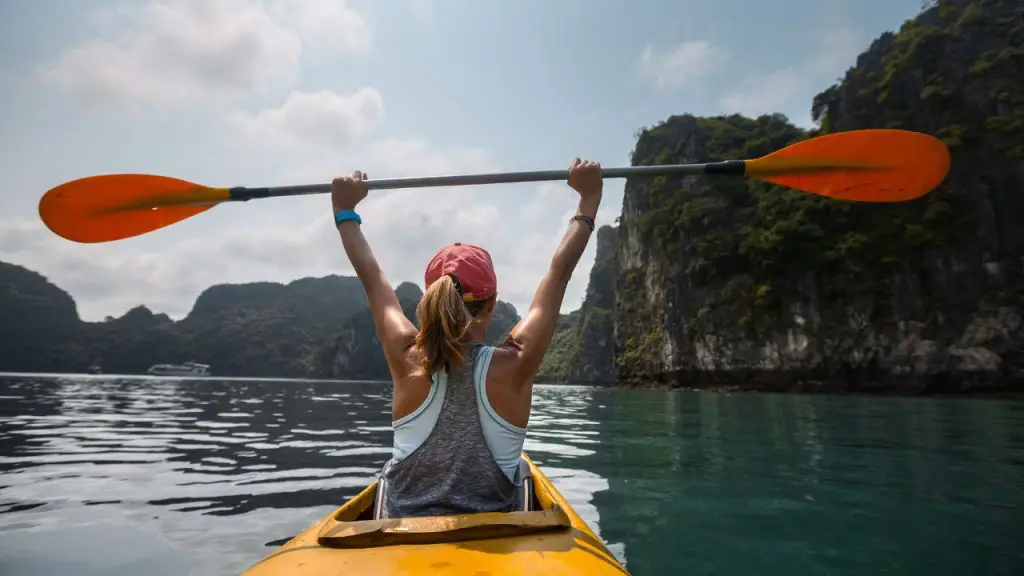 Woman is feeling excited while is kayaking