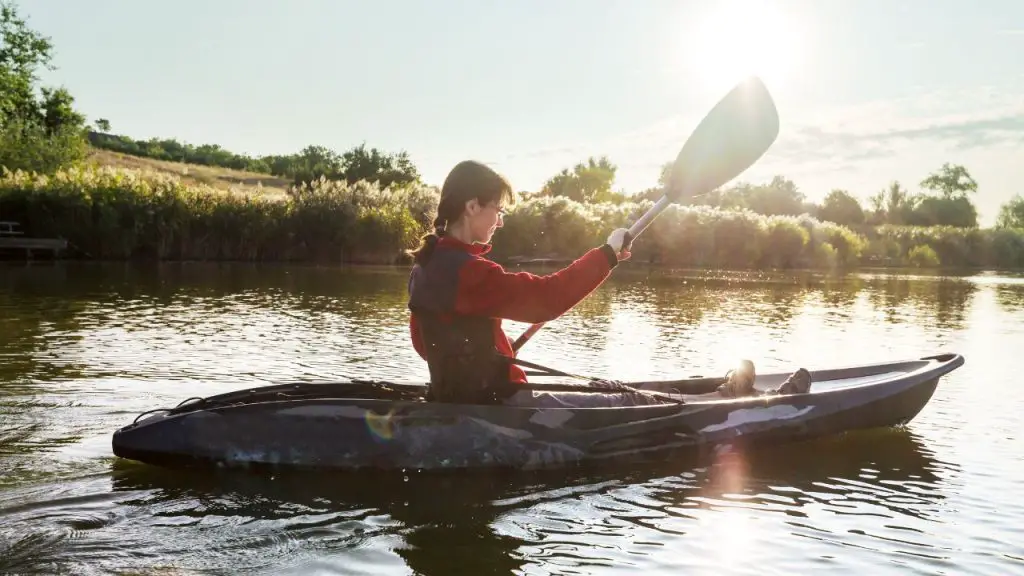 Woman is rowing a small kayak