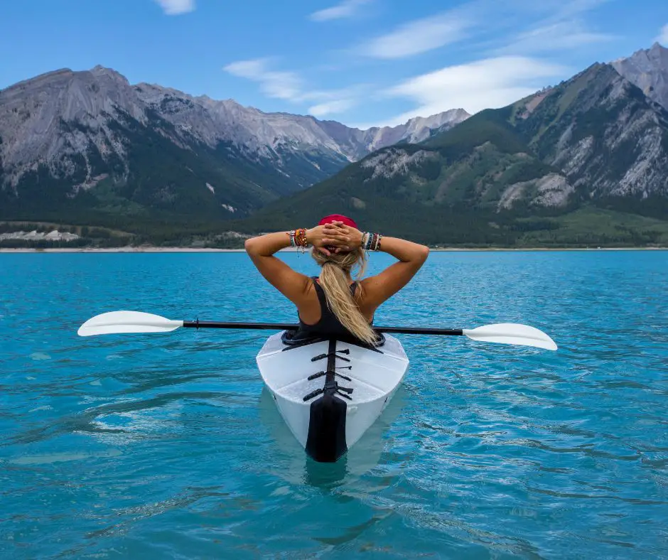 a girl is enjoying nature while kayaking