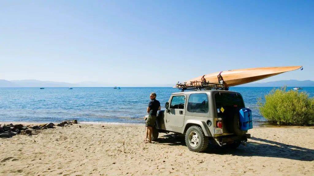 a man and kayak on a jeep