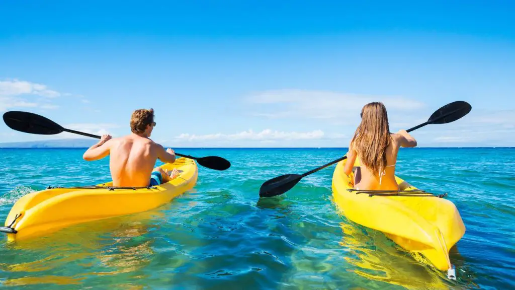 couple doing yellow kayaking in the sea