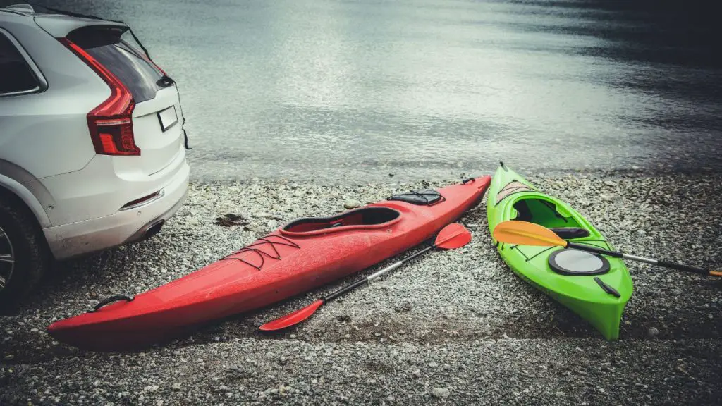 two kayaks and a car