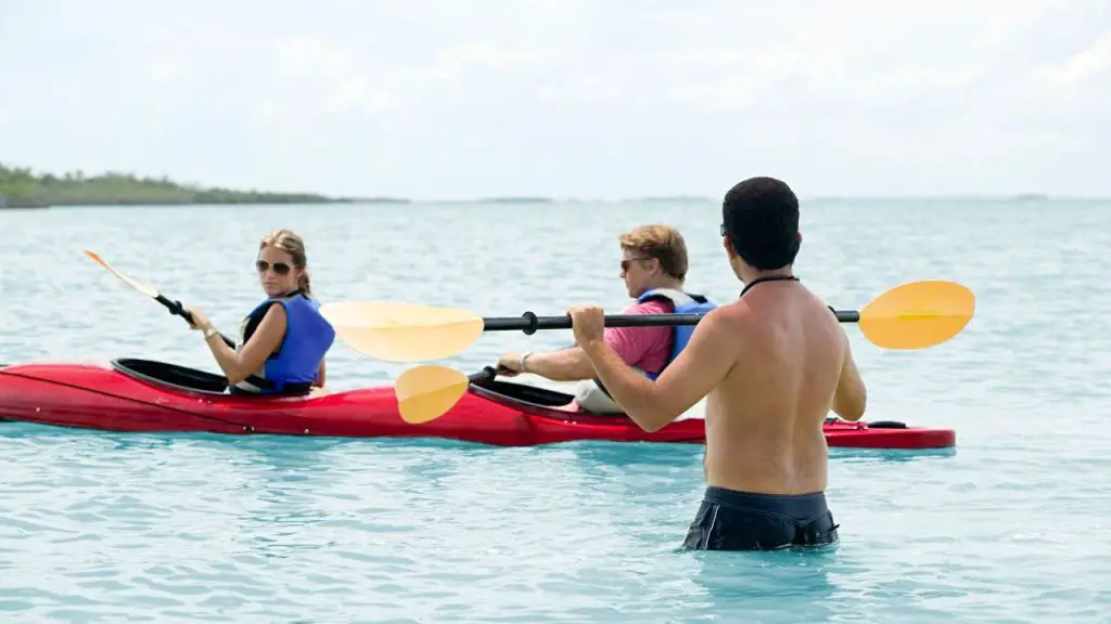 A Kayak instructor teaches the couple basic kayaking