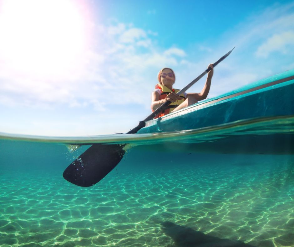 A girl is kayaking on the sea
