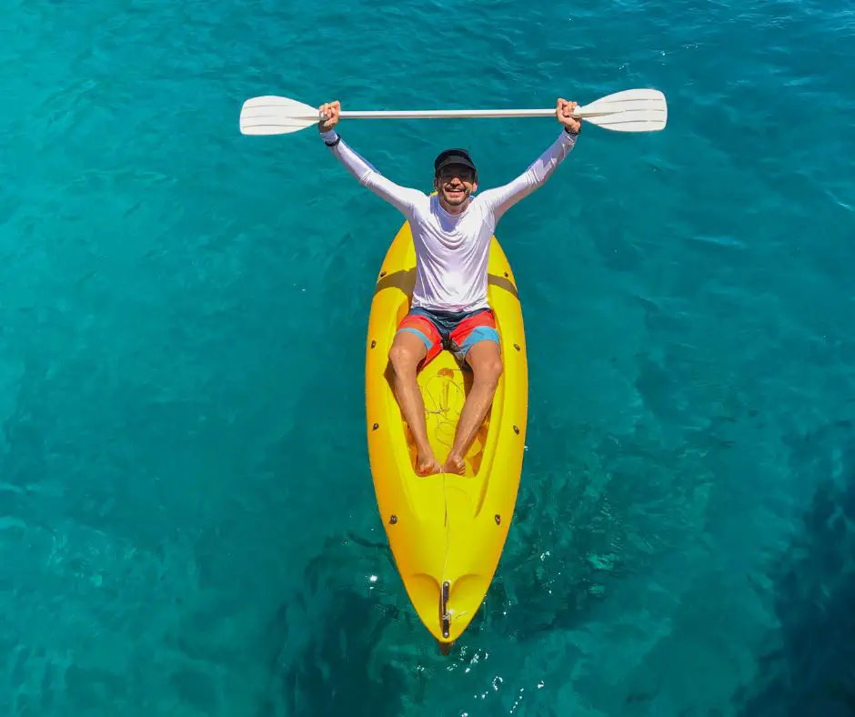 A man feeling excited while kayaking in the sea