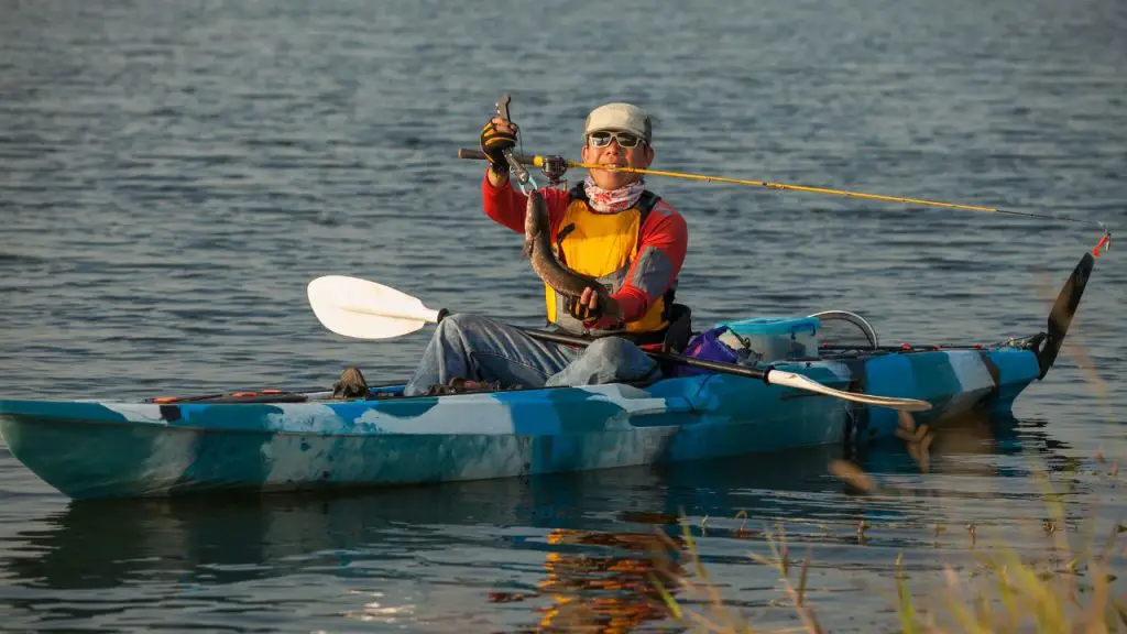  The man is fishing on the kayak