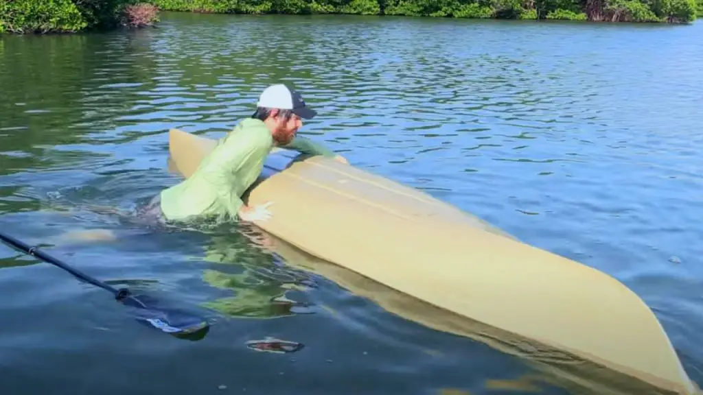 The man is trying to flip kayak