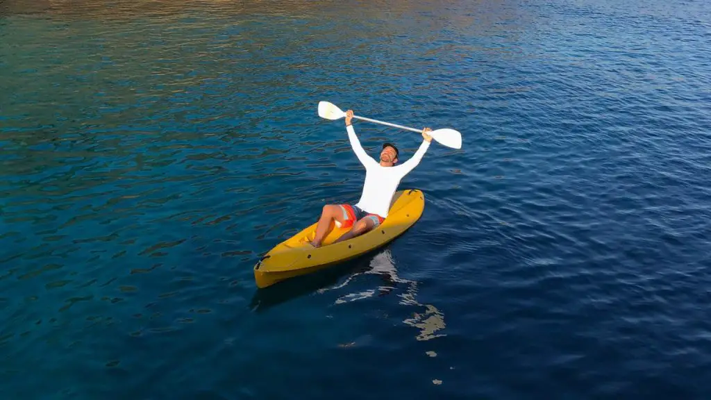 a man is feeling excited while kayaking