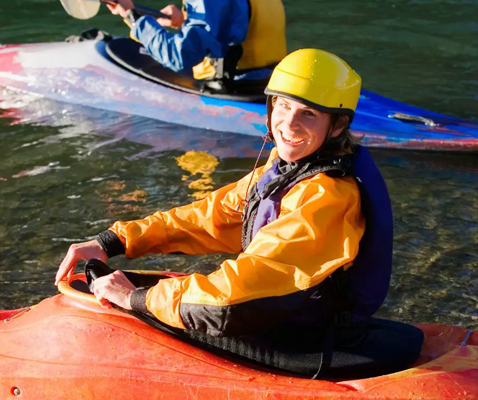 A man is smiling with sit-inside-kayak