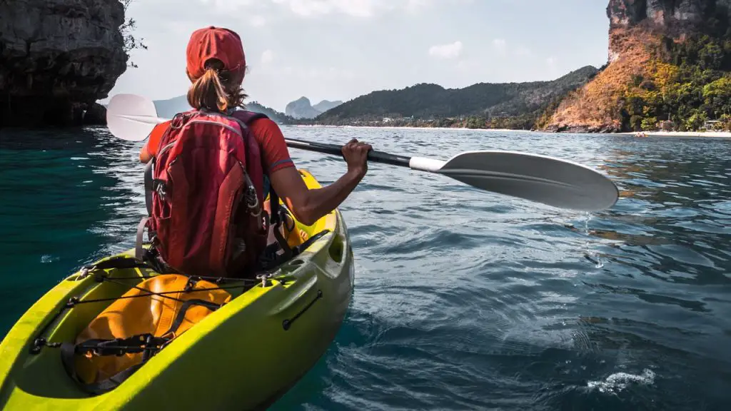 woman is kayaking with full equipment