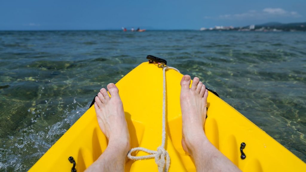yellow kayak and feet
