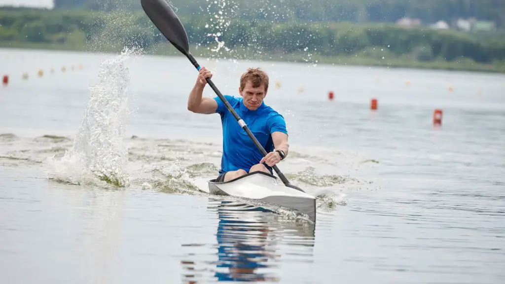 A wet man while speeding kayak