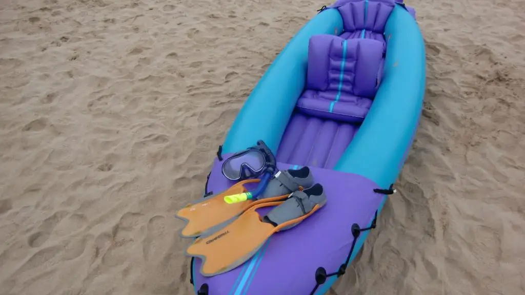 An inflatable kayak on the sand