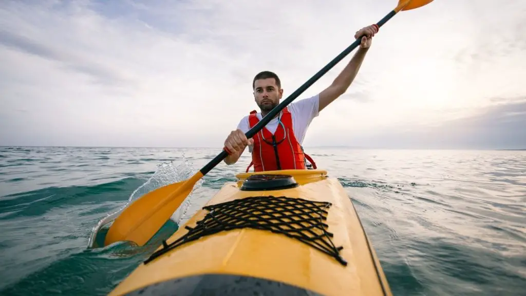 A man paddles ocean kayak