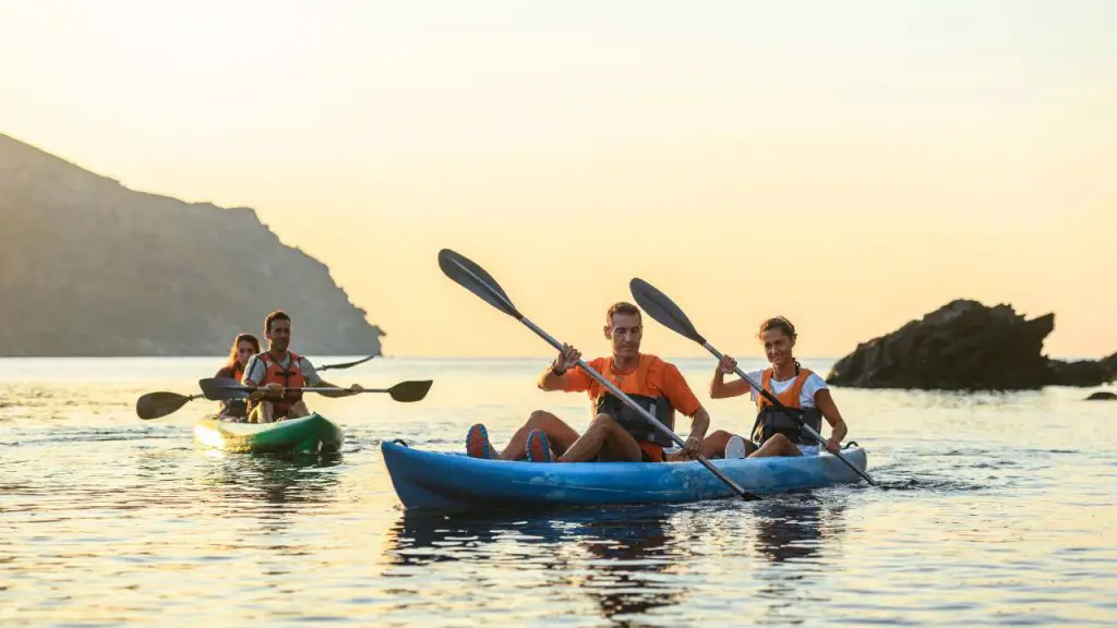 Couples are paddling tandem kayaks