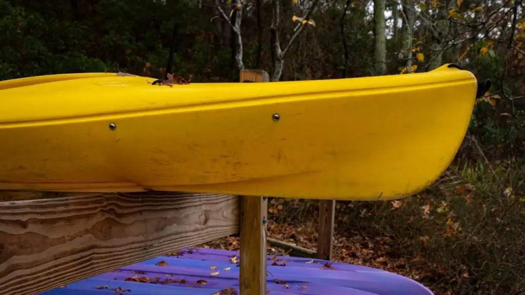 Kayaks are stored on rack but not covered