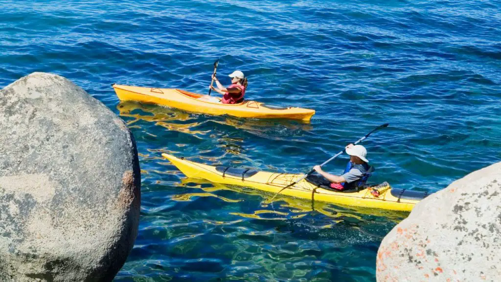 Two people are kayaking in the sea