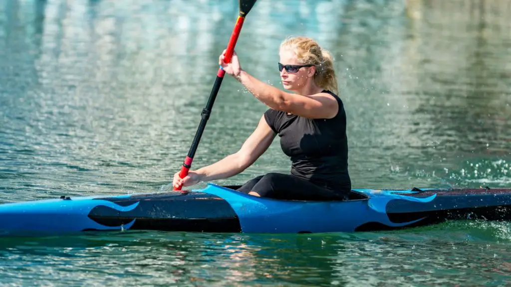 A girl is paddling kayak with warp