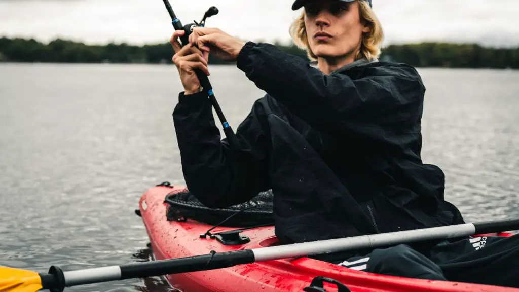 A man is fishing on kayak