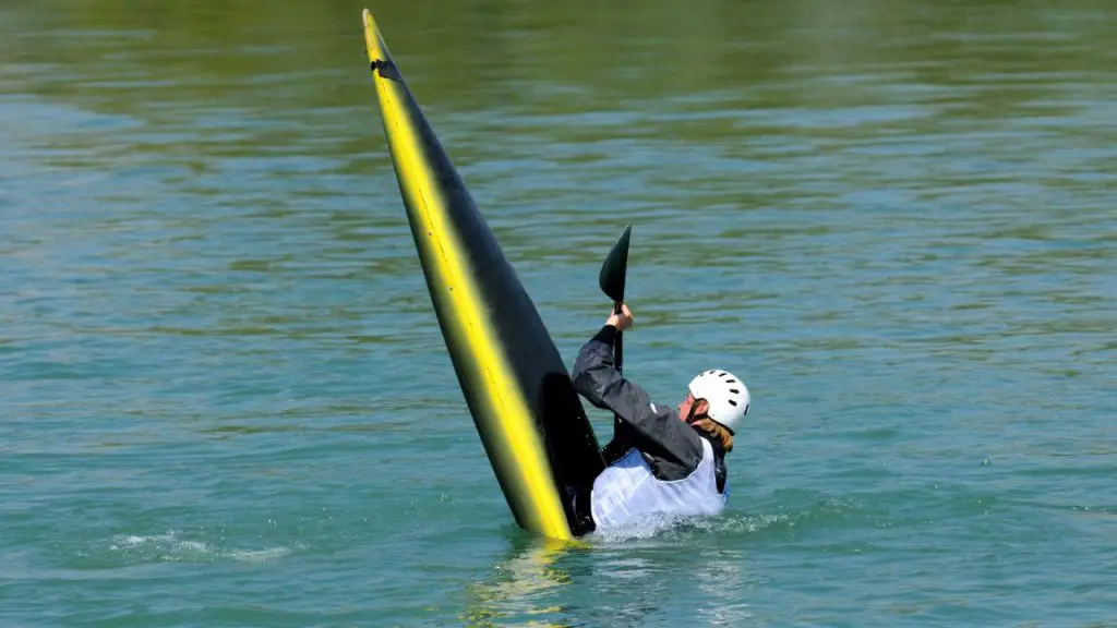 A man uses technique to keep his kayak from flipping. 