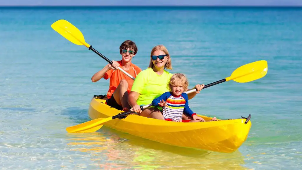 a woman is kayaking with their child's